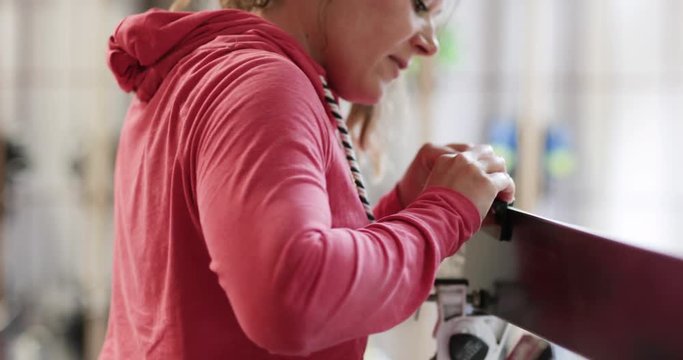 Craftsperson working in snowboard workshop