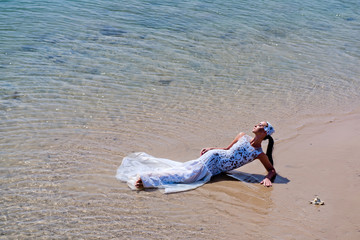 Woman lying on sea beach