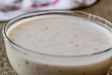 Organic probiotic milk kefir with flax seed in glass bowl.

