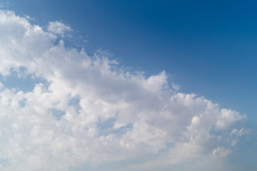 Diagonal white clouds on the blue sky