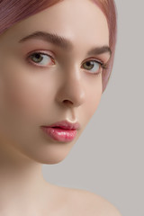 Macro shot of a portrait of the girl with a natural day make-up on a white background. Gently pink gloss of lipstick on lips. Spa, cosmetology, fashion, health