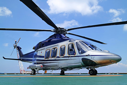 Helicopter or chopper land at oil and gas platform  area for get and sent passenger from onshore hangar to offshore platform    