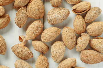 Almond in shell on a white table, top view