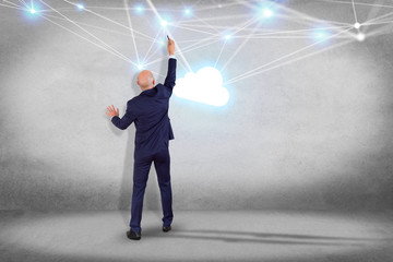 Businessman in front of a wall with a Cloud network with net and connection - Technology concept