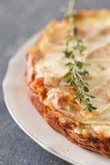 Fresh round fish pie on dark background