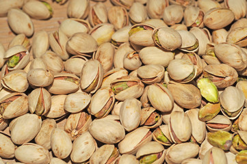 Pistachio texture. Nuts. Green fresh pistachios as texture. Roasted salted pistachio nuts healthy delicious food studio photo.