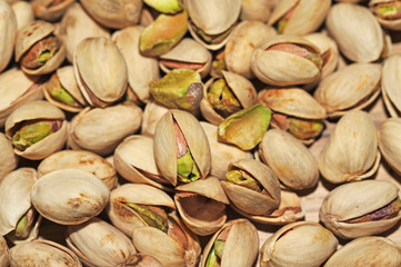 Pistachio texture. Nuts. Green fresh pistachios as texture. Roasted salted pistachio nuts healthy delicious food studio photo.
