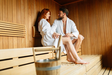 Beautiful couple relaxing in sauna