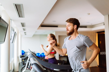 People running on treadmill in gym