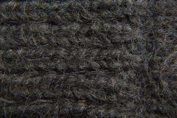 Extremely close-up. Black knitted scarf.