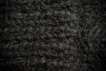 Extremely close-up. Black knitted scarf, texture.