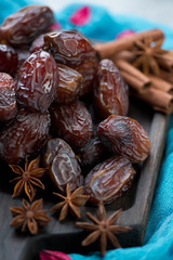 Close-up of date fruits with anise and cinnamon, selective focus, shallow depth of field