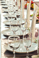 Preparation for the banquet. Rows of wine glasses.