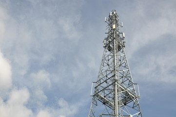 Telecommunication tower with blue and cloudy sky