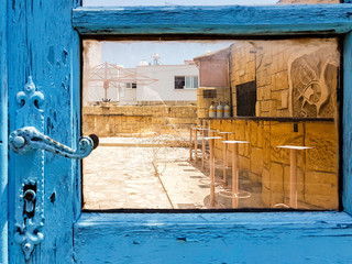 Deserted terrace behind a colorful door.