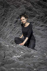young woman, portrait in front of basalt cliffs in hellnar, iceland