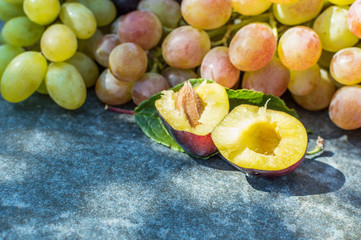 grapes and plums in the basket