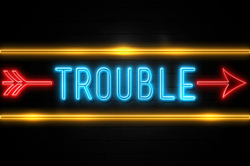 Obraz premium Trouble - fluorescent Neon Sign on brickwall Front view