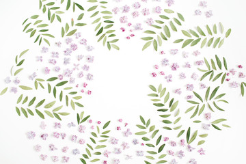 Fototapeta na wymiar Frame of lilac flower petals, green leaves with space for text on white background. Flat lay, top view