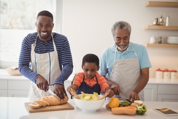 Multi-generation family preparing food in kitchen