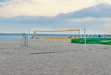 Beach volley net near sea blue water, field close up