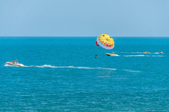 ALBENA, BULGARIA - JUNE 15, 2017: Colored parasail wing pulled by a boat in the sea water, Parasailing also known as parascending or parakiting