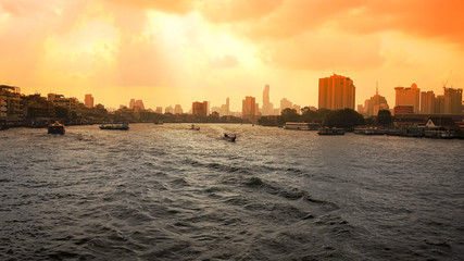 Bangkok Skyline and Boats on Chao Phraya River at Sunrise in Thailand