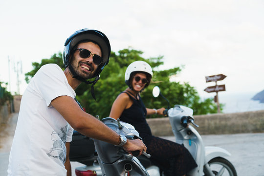 Smiling people posing on scooters