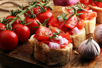 Bruschetta with tomatoes, herbs and oil on toasted garlic cheese bread toasted with chopped tomatoe
