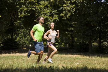 Fototapeta premium Young couple running in nature