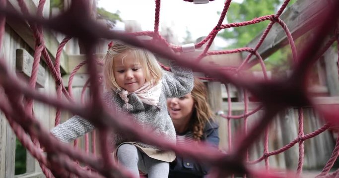 Mother and daughter in playground playing