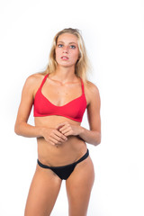 Fototapeta premium stupendous girl young blonde, in bikini on white background ,perfect body 