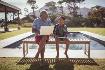 Grandfather and grandson interacting with each other near