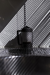 coffee machine in the kitchen. Beautiful light from the window blind. stripes