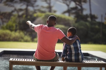 Father pointing something to his son