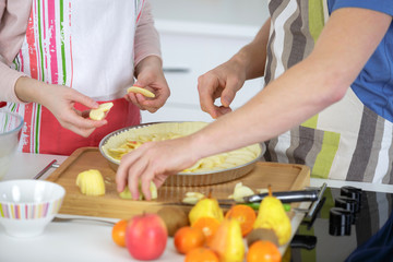 couple preparing an apple pie