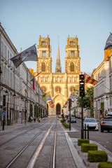 Naklejka na ściany i meble Street view with famous cathedral during the sunset in Orleans city in central France