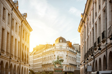 Fototapeta premium Street view on the Martroi square with statue of Saint Joan of Arc in Orleans city during the sunset in France