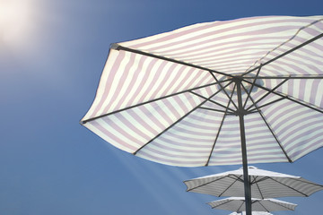 beach striped umbrellas on a Sunny day
