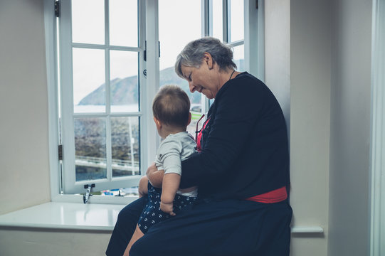Senior woman with grandchild by the window