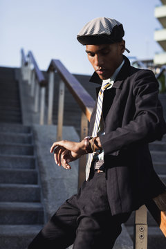 Businessman waiting outdoor and checking the time