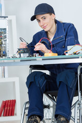 female disable worker fixing a computer