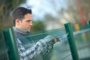 worker putting up a garden fence