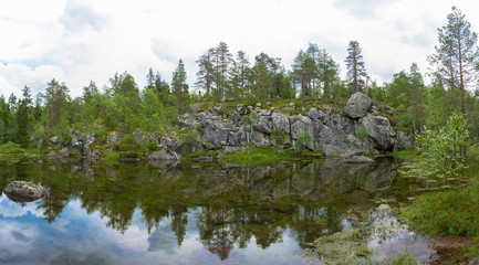 Fototapeta na wymiar A small lake in the rocky shores of Karelia.