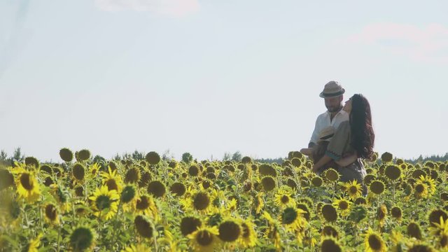 Happy family embraces at the sunflowers field