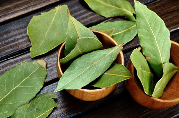 bay leaf in bowl on wooden table