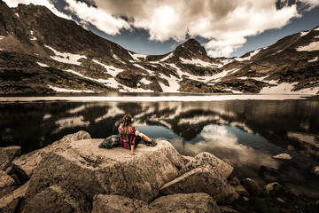 Tourist in Colorado Hiker Girl rests at Blue lake Mt Toll Trail Indian peaks wilderness