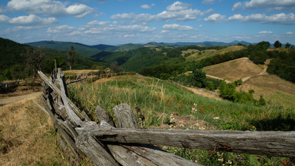 Landscape with old woody fence and hills in Romania