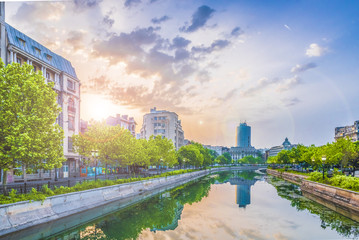 Dambovita river and center of Bucharest at sunset time, Romania.