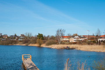 Fototapeta na wymiar A wooden pier in town of Nyraad in Denmark